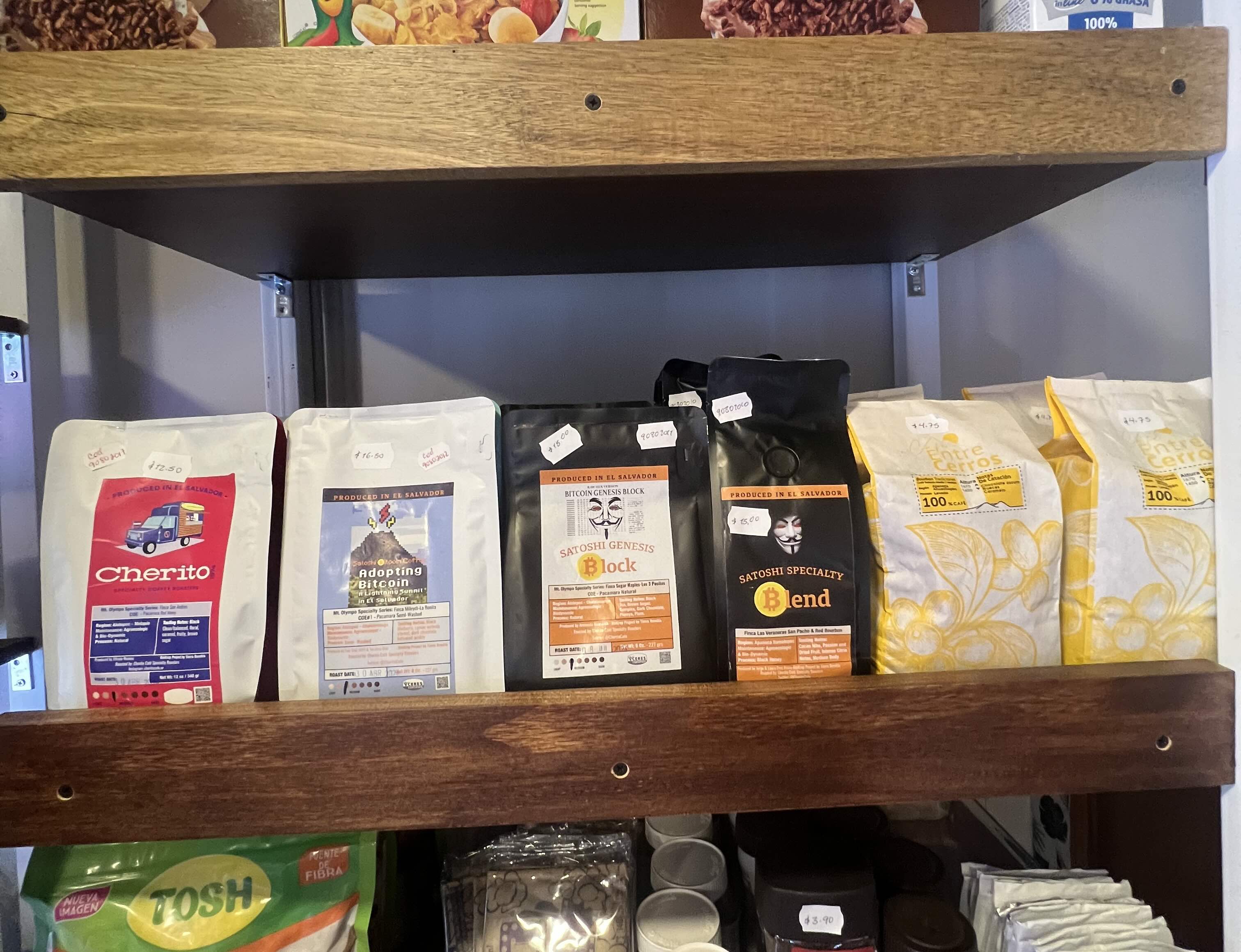 El Salvadoran Bitcoin coffee bags featuring Bitcoin-themed art on display in a grocery store.